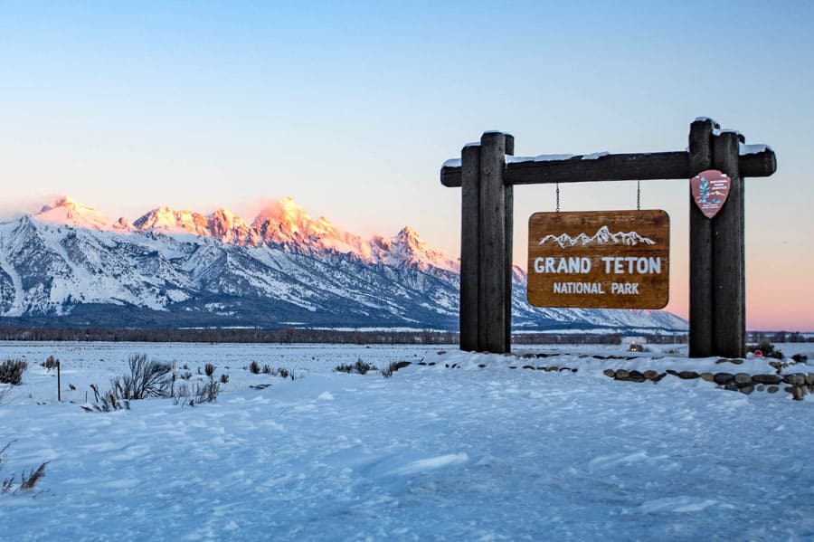 grand teton national park sign with mountains